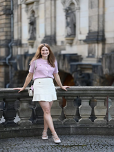 A woman wears a pink chenille cardigan